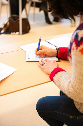 teacher writing in notebook